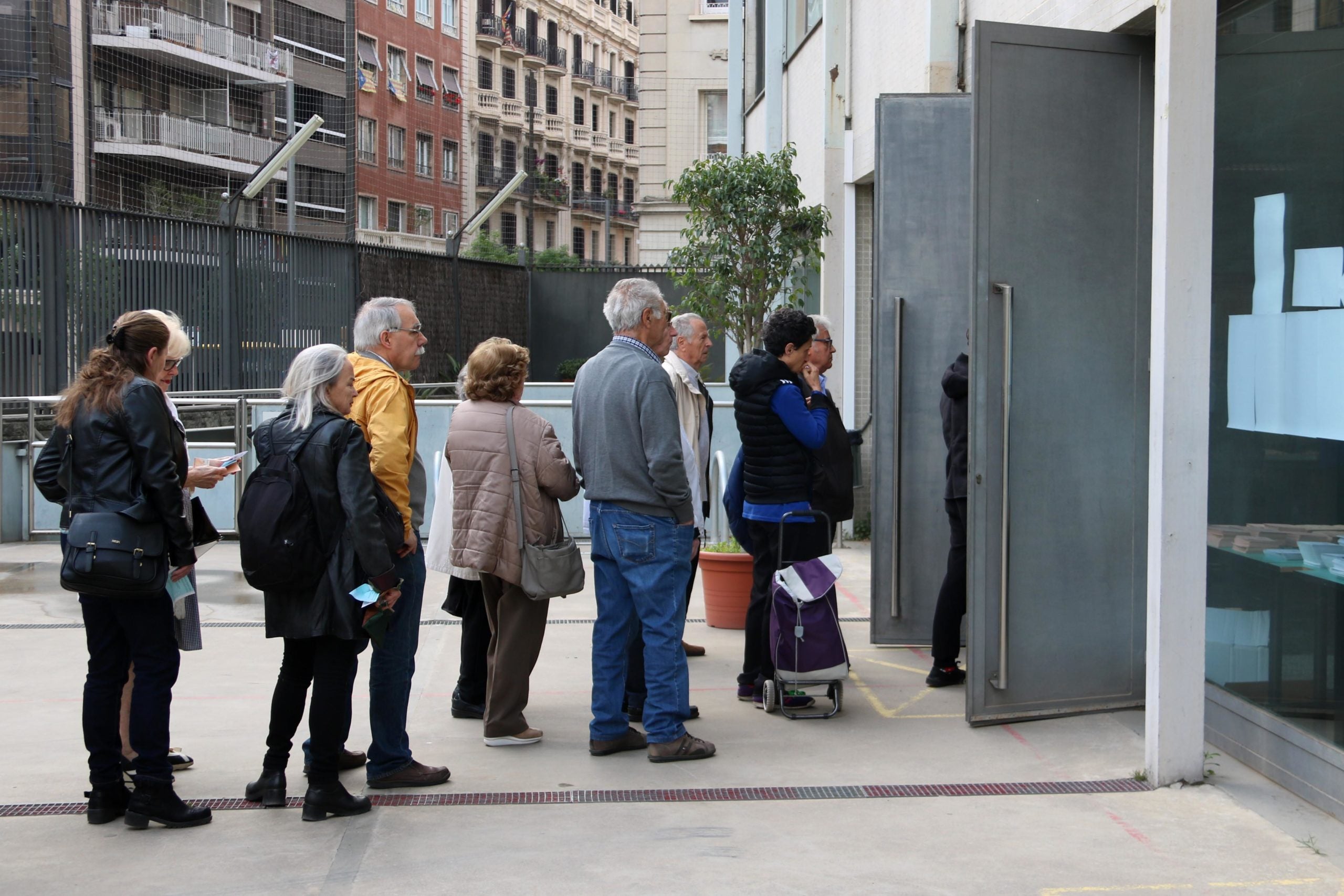 Cues d'electors esperant perquè obrin el d'Escola Oficial d'Adults de Sant Gervasi. / ACN (Aina Martí)