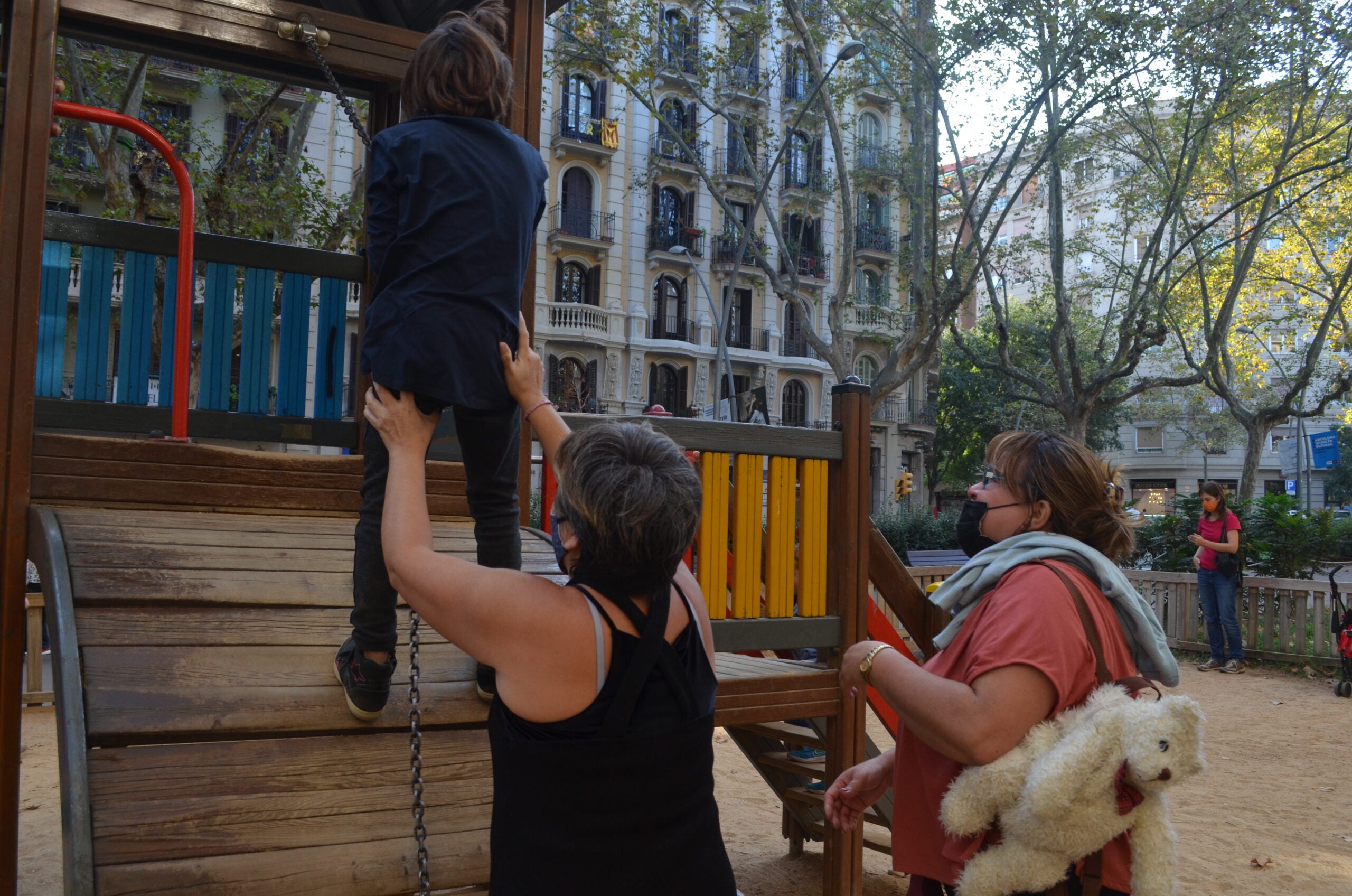 Eliane Baldomar ajuda la seva filla al parc / Adrià Lizanda
