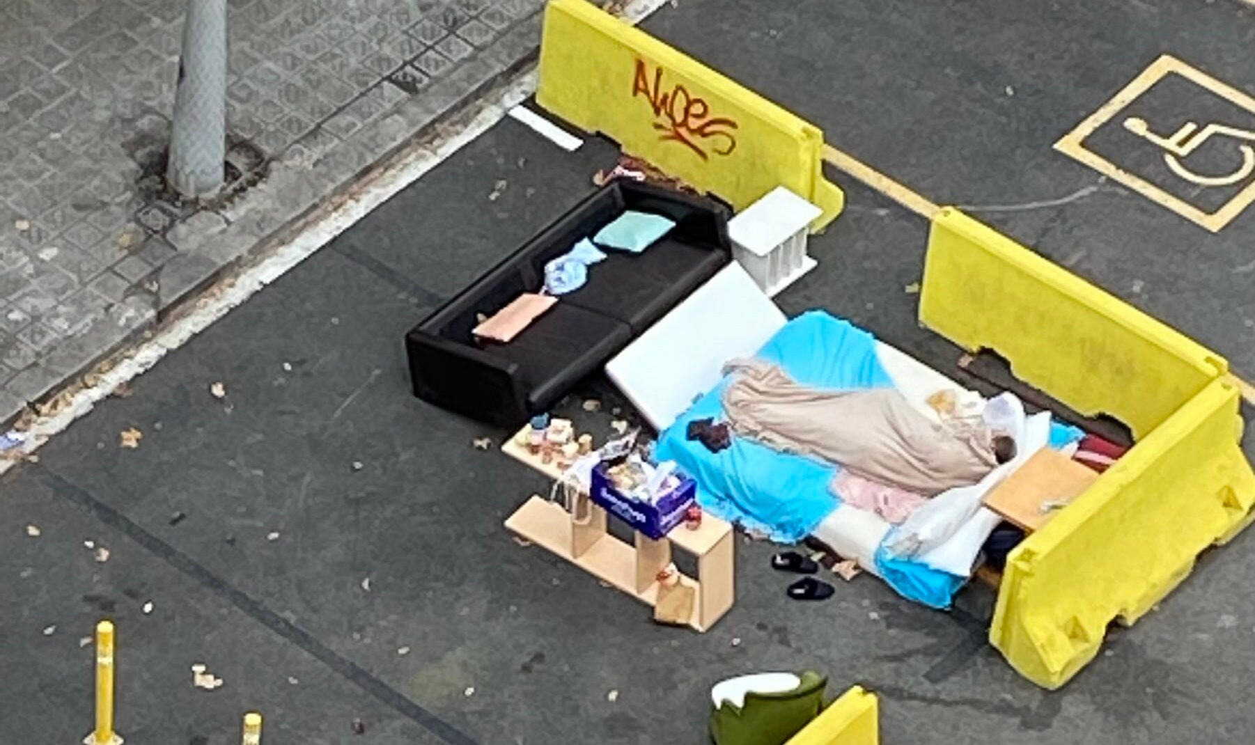 Una persona dormint al carrer Consell de Cent amb Entença, en un dormitori muntat en una terrassa / Joan Sala
