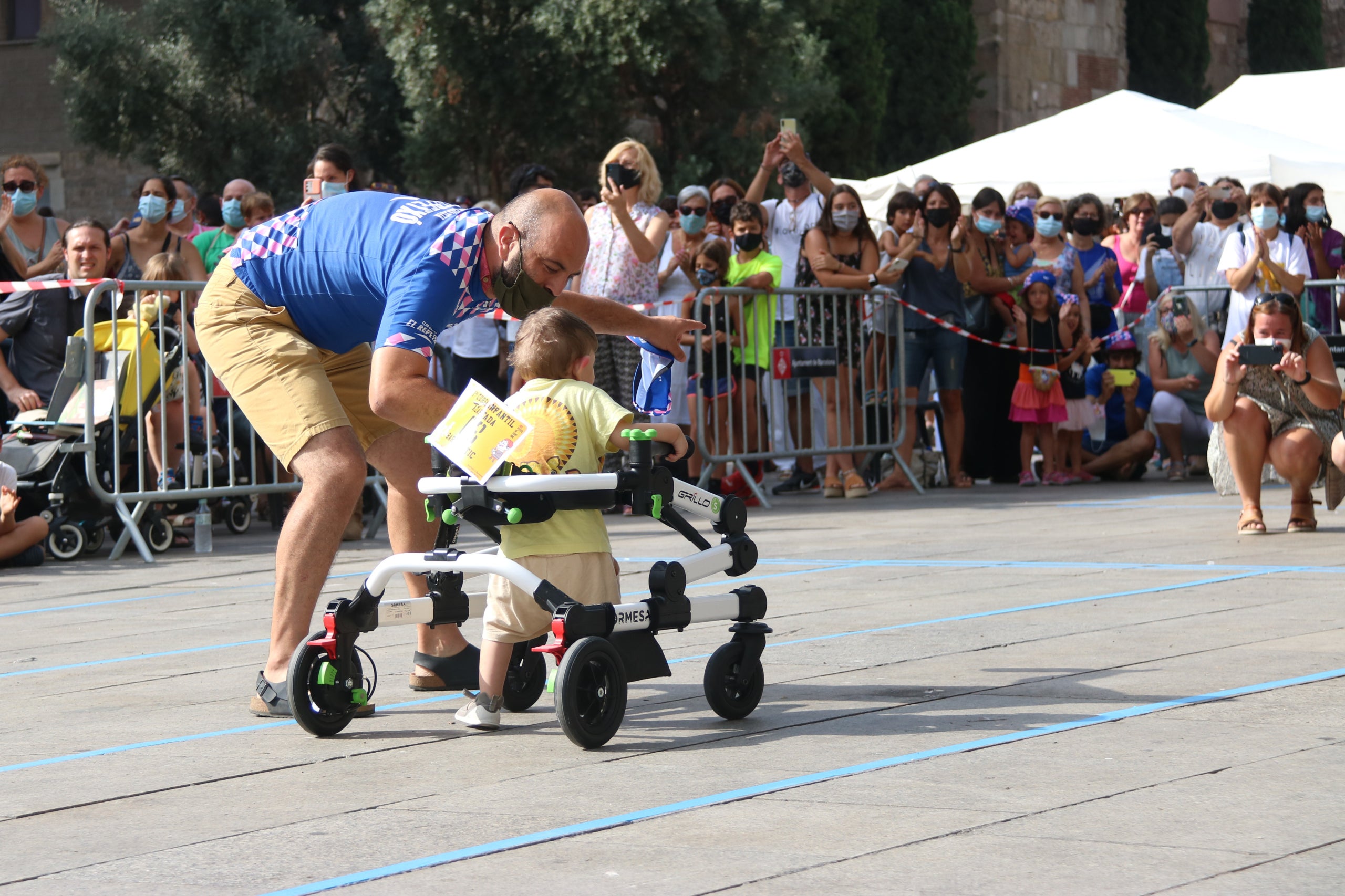 Un pare animant el seu fill en la primera cursa infanil adaptada de Barcelona / Carola López / ACN