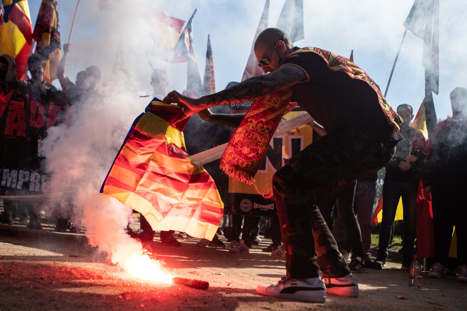 Un home crema una bandera estelada a la manifestació neonazi del 12-O / Europa Press