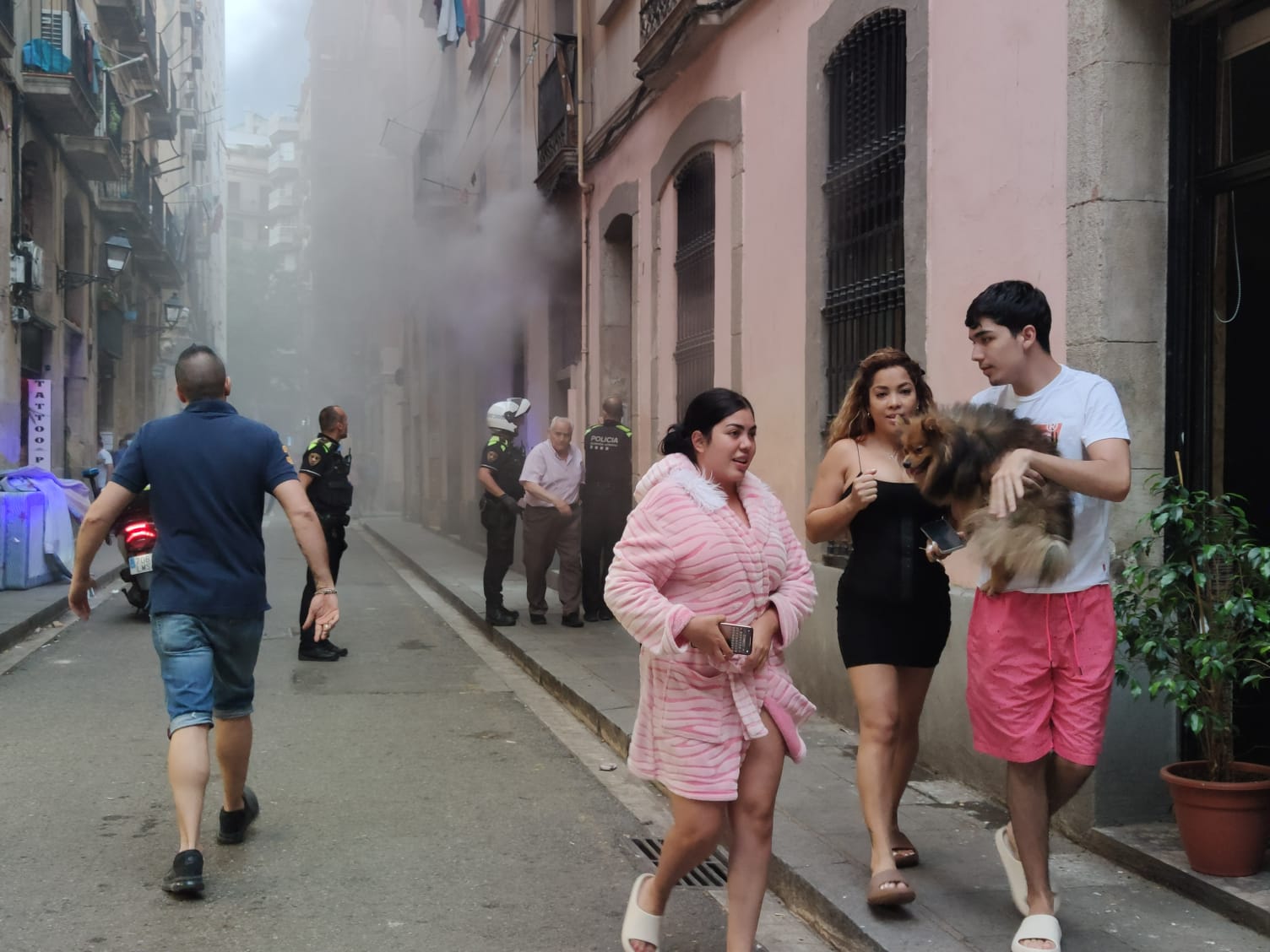 Una columna de fum surt dels baixos que s'han incendiat en un edifici del Raval / JAG