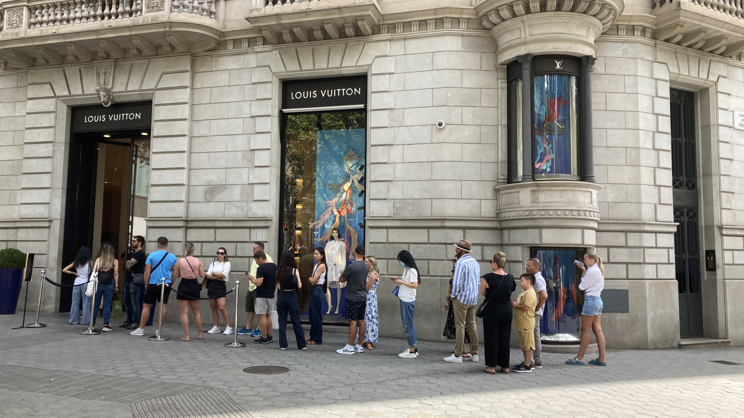 Persones esperant per entrar a la botiga de Louis Vuitton a Passeig de Gràcia / Pol Mestres Bosch