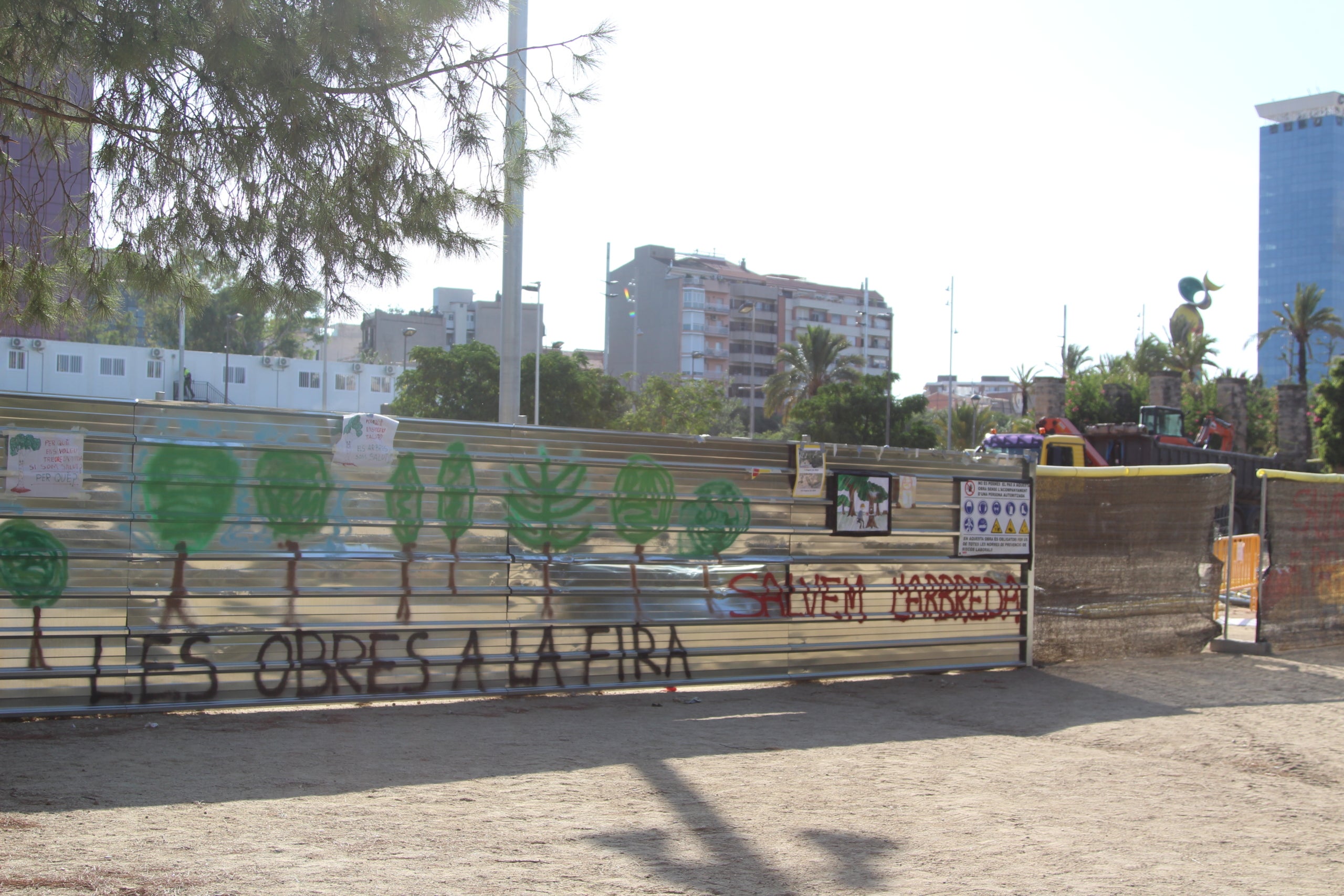 Pancartes que flanquegen la tanca que delimitada la zona del parc de Joan Miró afectada / A.R.